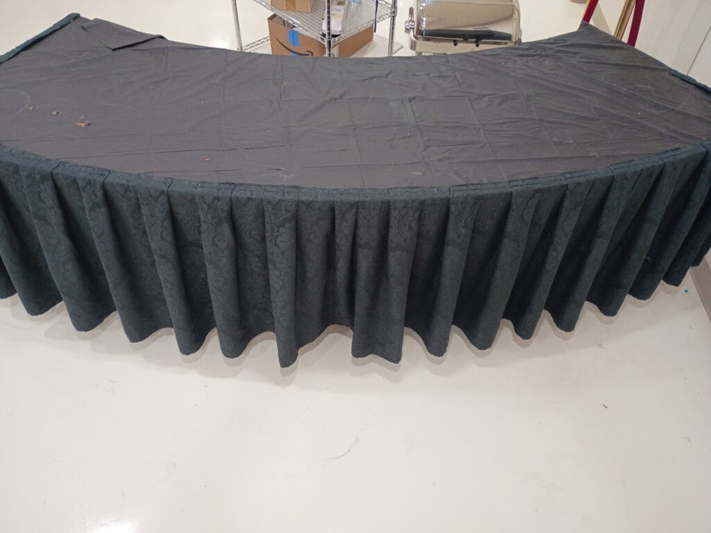 Half circle table with stapled cover